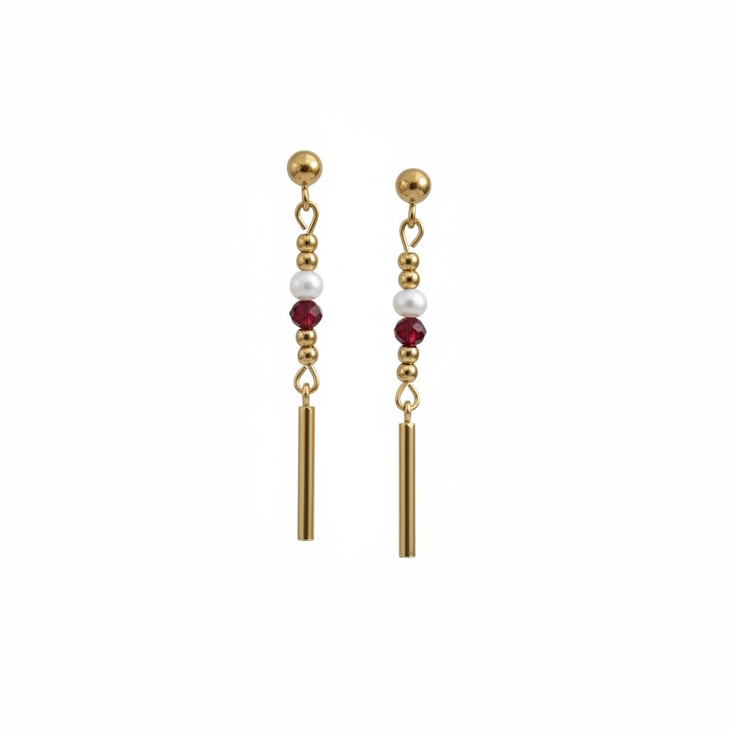 Florence by the Ocean gold drop earrings with white pearls and ruby-red crystal beads on a minimalist bar silhouette.
